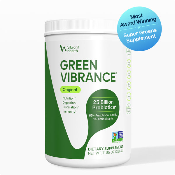 A white plastic tub of Vibrant Health Green Vibrance Original dietary supplement with green and white label design, featuring a blue circular 'Most Award Winning' badge overlay on the top right, set against a clean white background.
