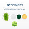 Promotional graphic for a supplement or blend product with the headline 'Full transparency' and supporting text about fully disclosed ingredients. Below, four small ingredient bowls are shown on a white background: green grass, white powder, dark green powder, and yellow granules.